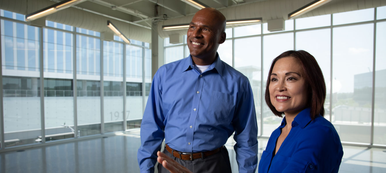 Two people looking at an office building.