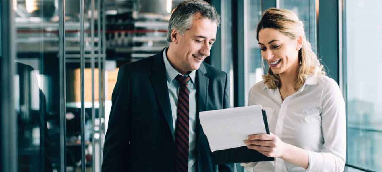 two people looking over paperwork