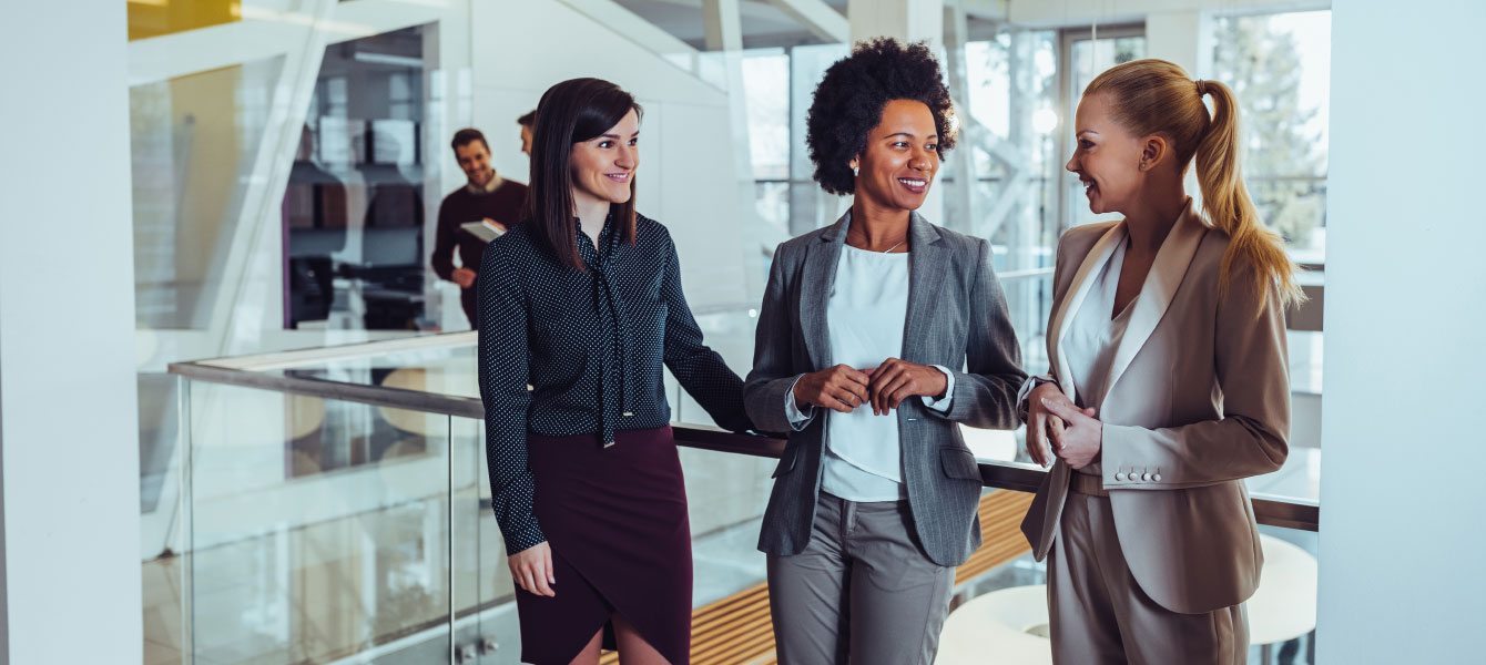 Three business women talking.