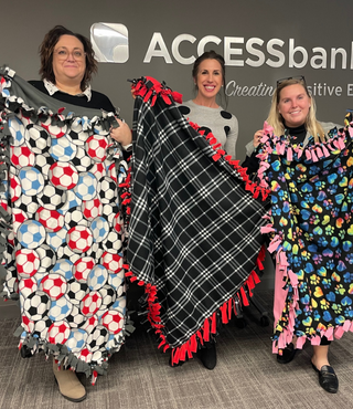 Handmade blankets from ACCESSbank employees being donated to charity 
