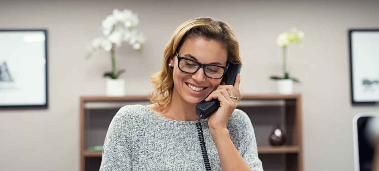 person at a desk using phone