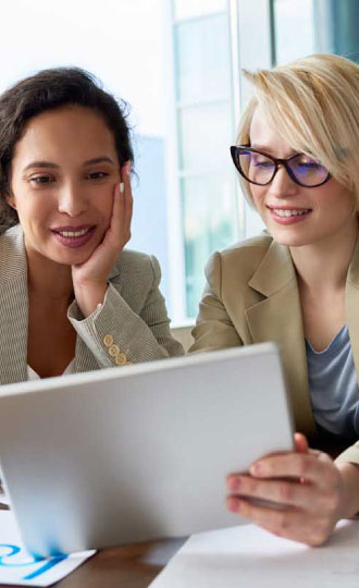 Two women looking at an iPad.