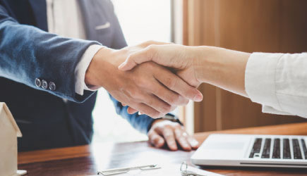 Woman and man shaking hands.