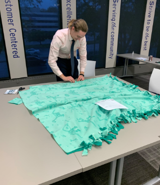 ACCESSBank team participating in Project Linus by making blankets for ill or traumatized children.